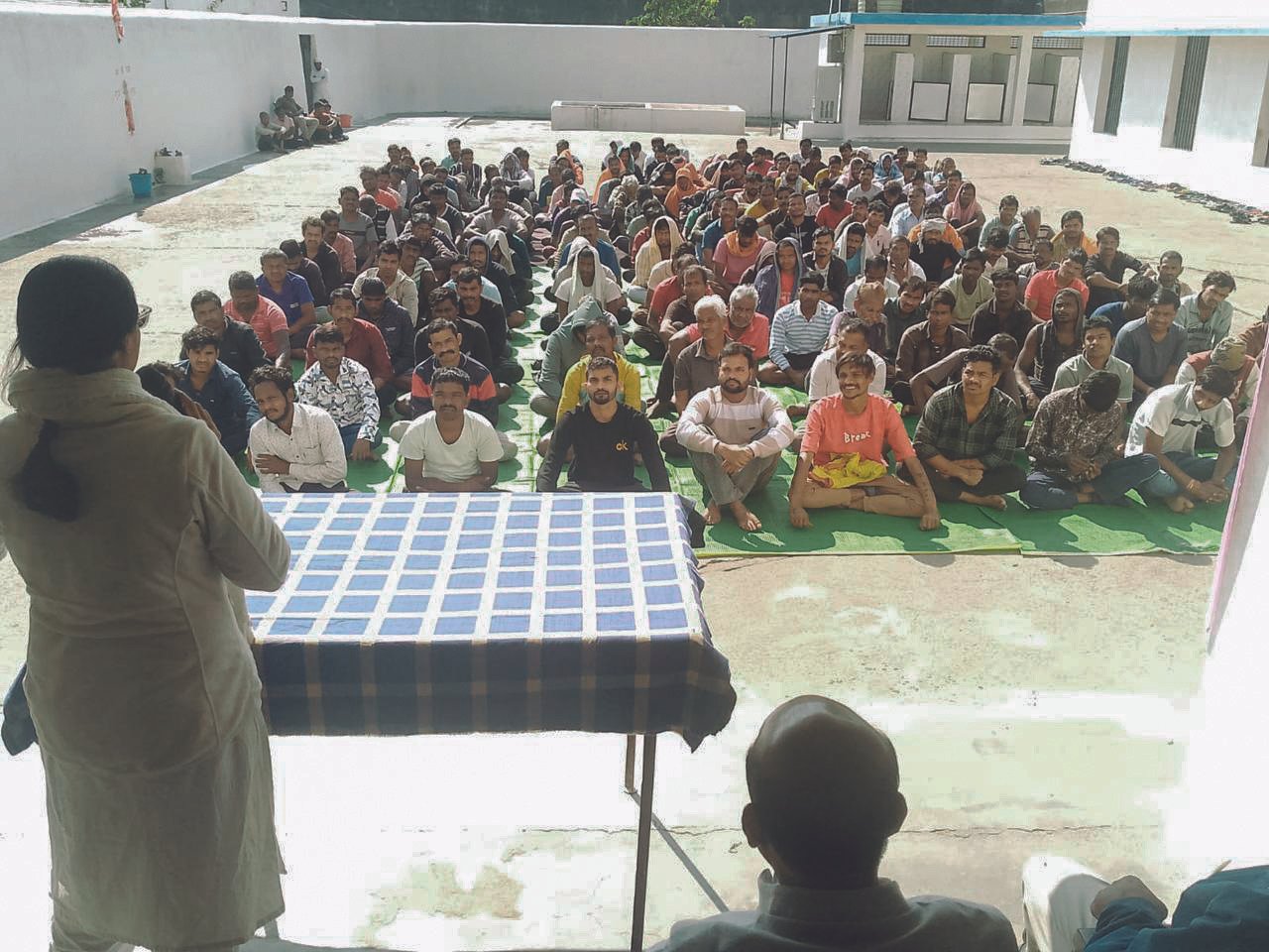 A seated group of listeners during a talk at Katghora Jail, Korba
