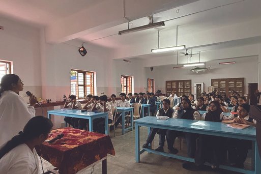 Smriti Budhia speaking to a small classroom during the Kerala tour