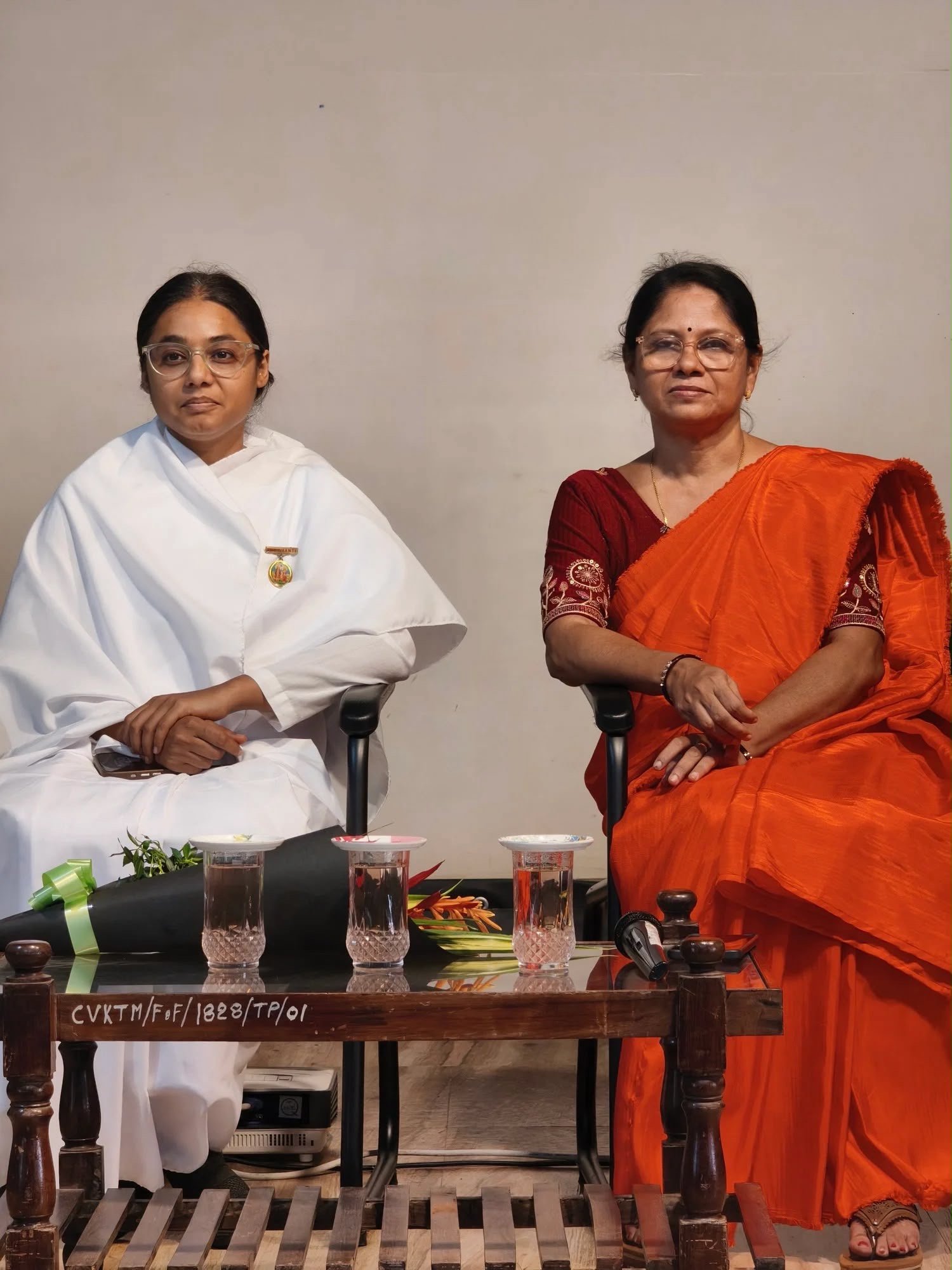 Smriti Budhia seated beside a guest during a conversation