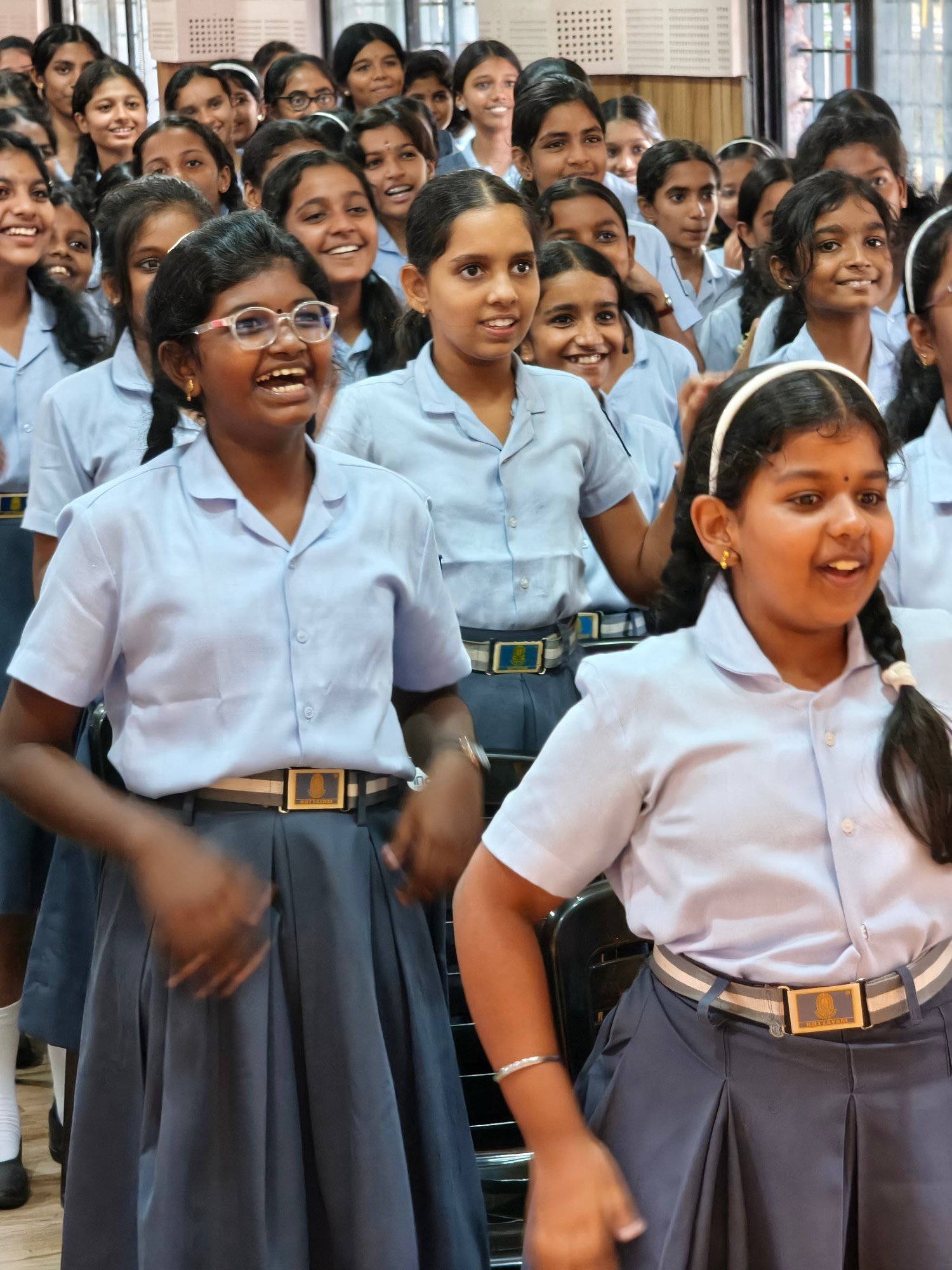 A school hall of students laughing during a session