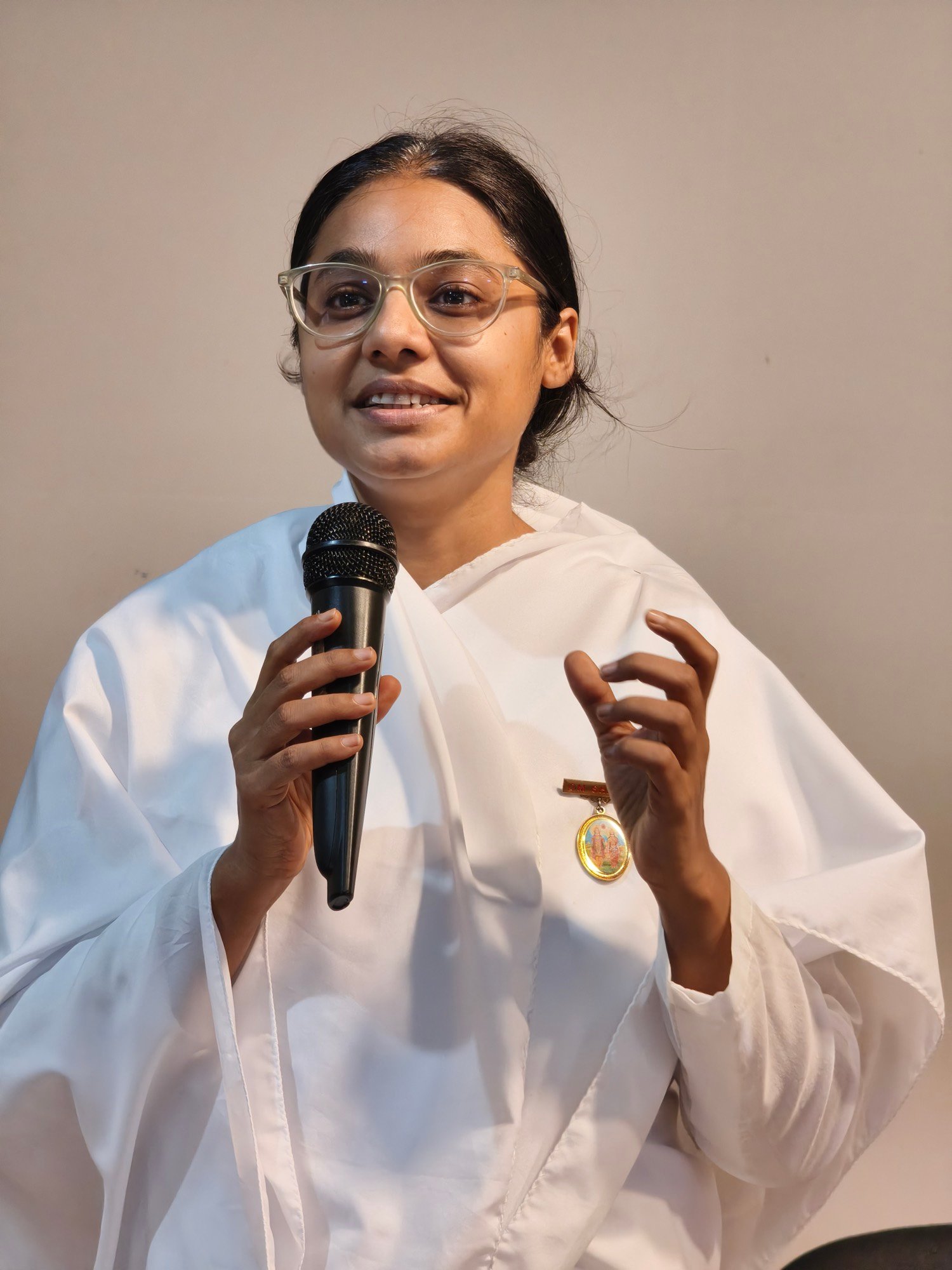 Smriti Budhia speaking into a microphone during a talk